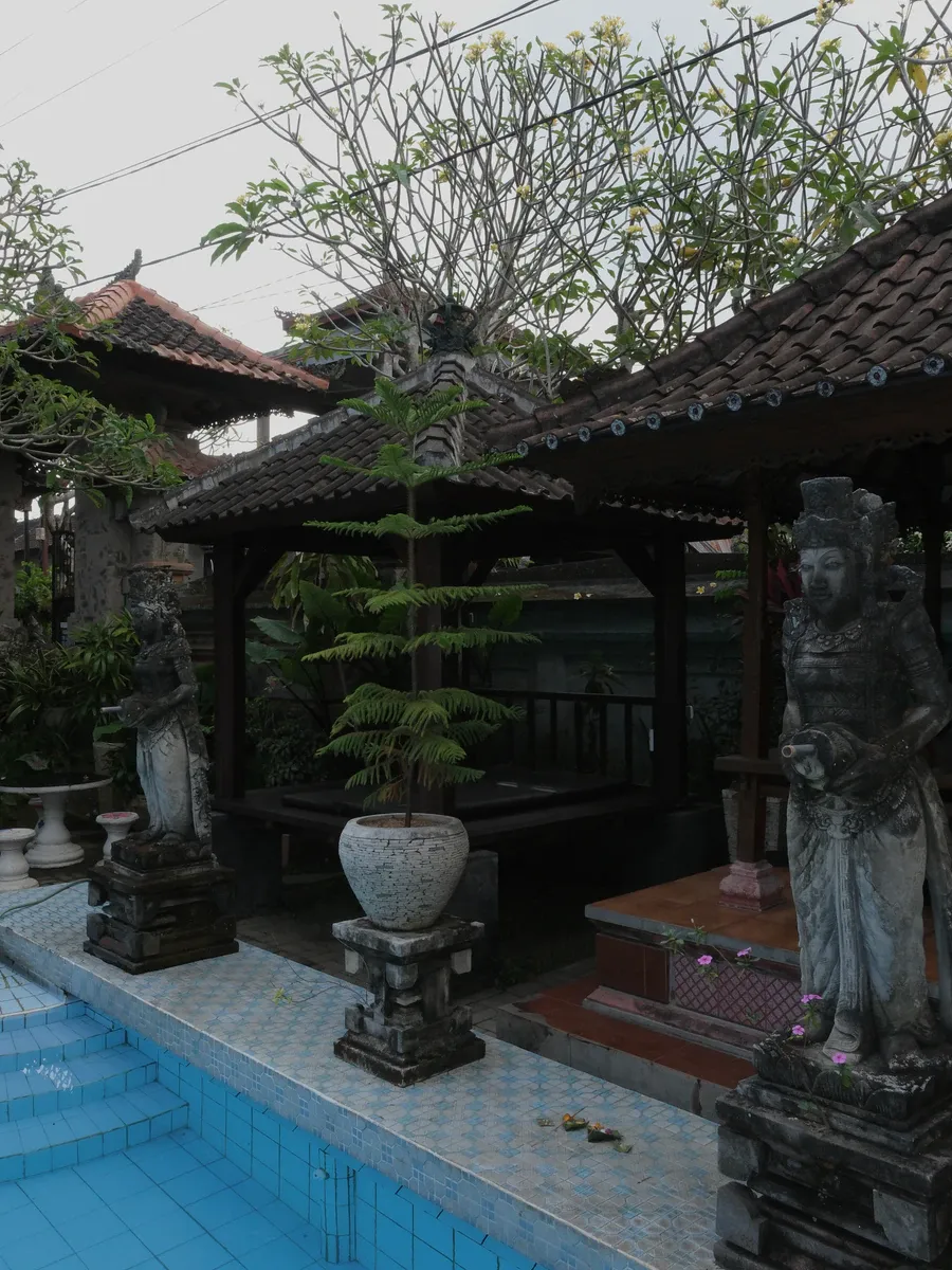 Poolside gazebos with Balinese stone statues